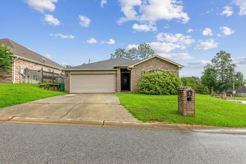 4640 Hermosa Road Crestview, FL 32539 - Photo 2 of 37 a front view of a house with a yard and garage