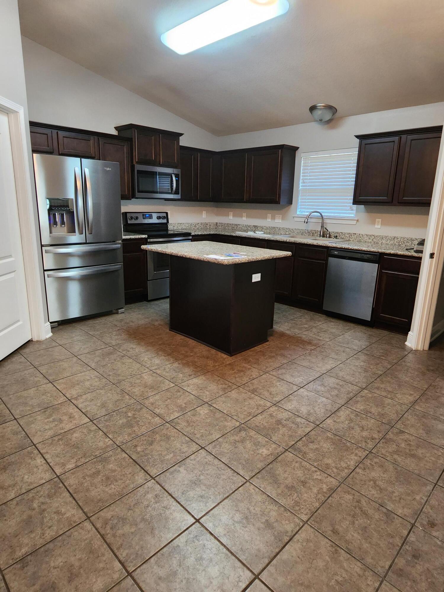4640 Hermosa Road Crestview, FL 32539 - Photo 30 of 37 a kitchen with stainless steel appliances granite countertop a sink stove and refrigerator