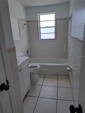 a bathroom with a granite countertop toilet a sink and a shower