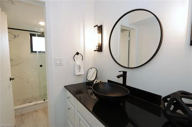 a bathroom with a shower and a mirror