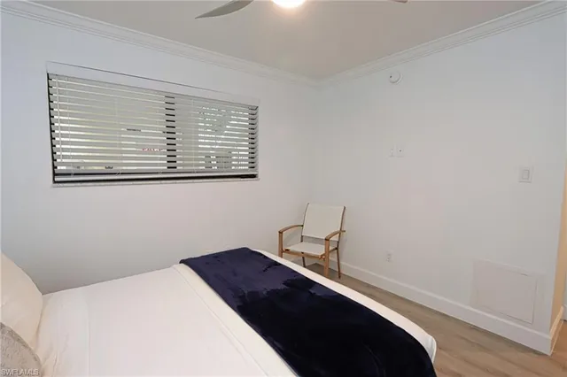 a bedroom with a bed and a lamp