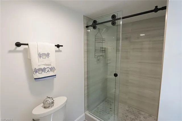 a view of a hallway with couch and lounge chair