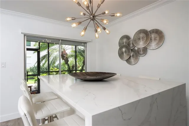 a bedroom with a bed and a lamp on the dresser