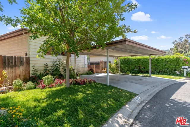 a view of a backyard with table and chairs under an umbrella