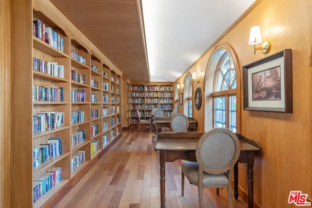 a view of a livingroom with furniture staircase and a window