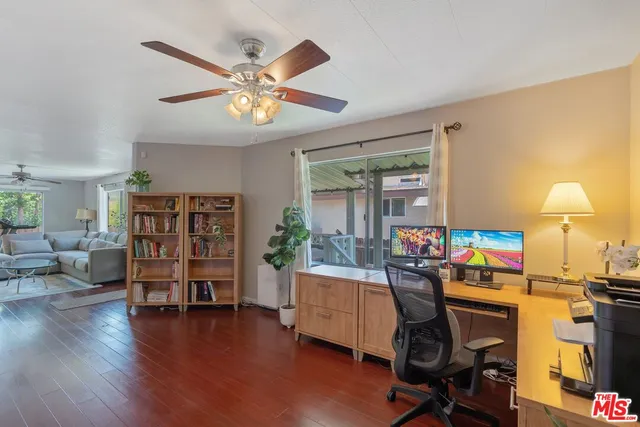 a view of a workspace with furniture and wooden floor
