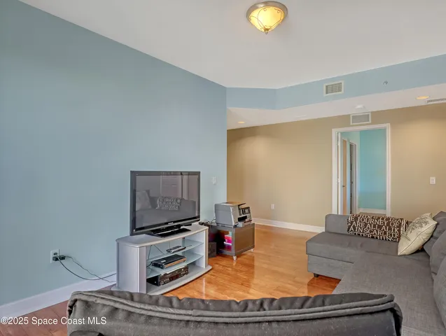 a view of a livingroom with furniture and hardwood floor