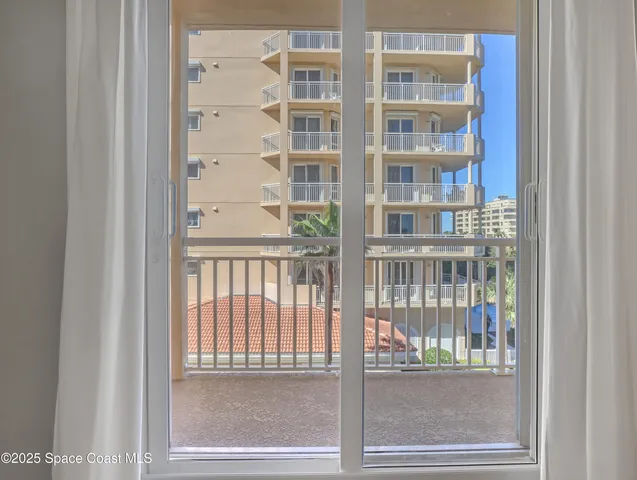 a view of a patio with table and chairs with wooden floor and fence