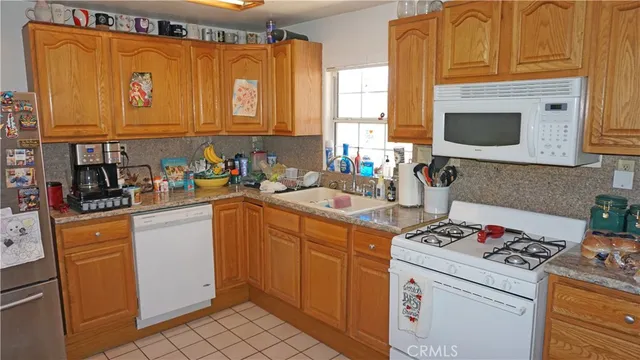 a kitchen with stainless steel appliances a stove microwave and cabinets