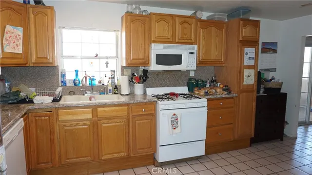a kitchen with granite countertop cabinets and window