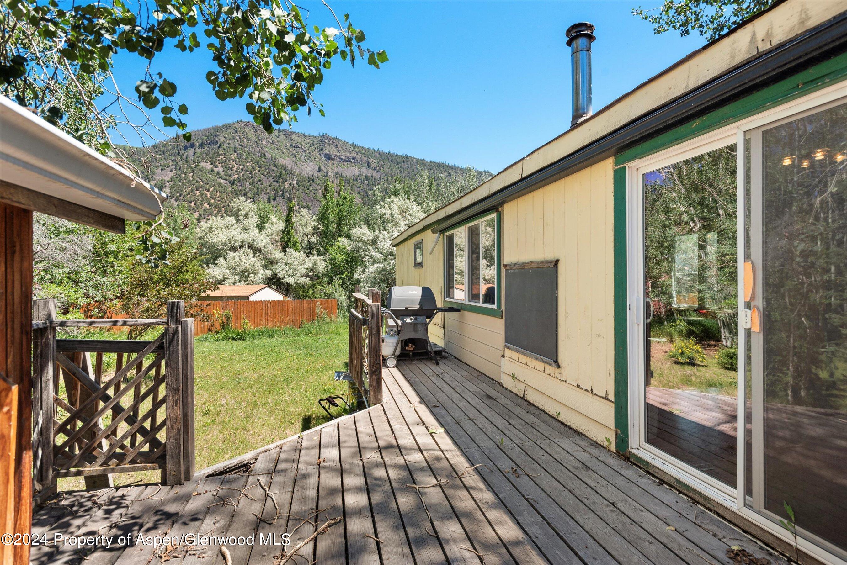 40 Aspen Village Road Aspen, CO 81611 - Photo 15 of 19 a view of a balcony with chairs and wooden floor