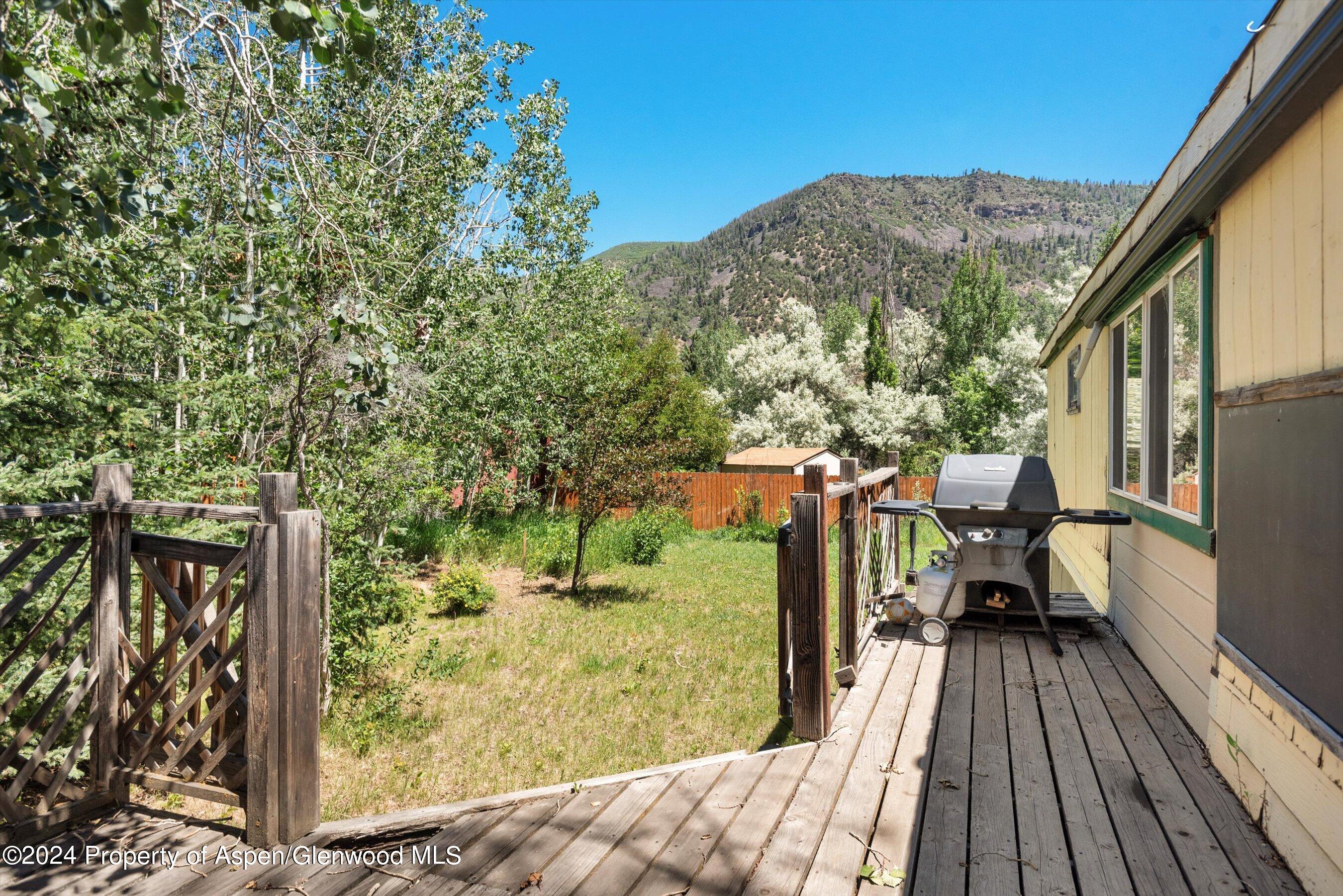 40 Aspen Village Road Aspen, CO 81611 - Photo 16 of 19 a balcony with wooden floor and outdoor seating