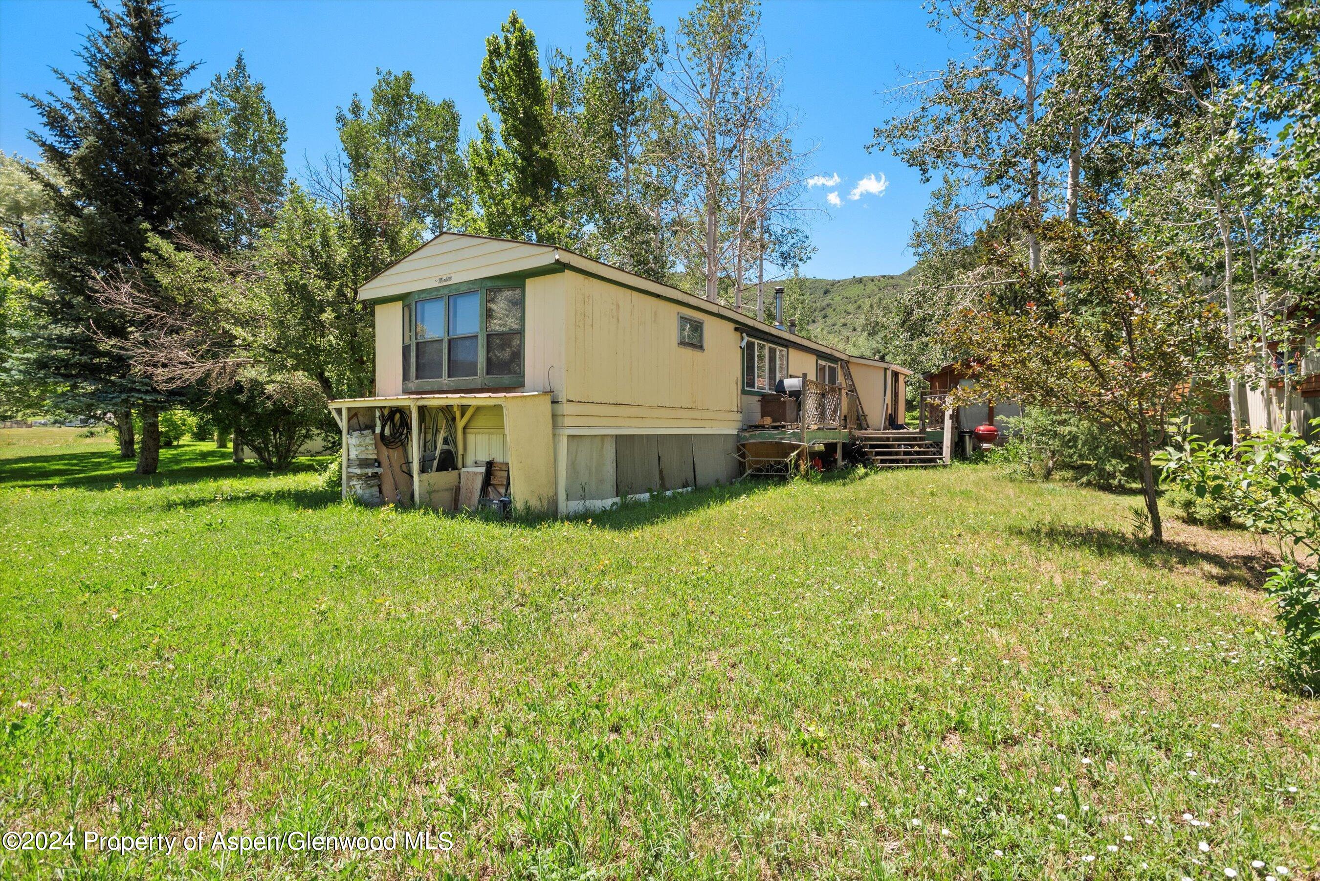 40 Aspen Village Road Aspen, CO 81611 - Photo 18 of 19 a white house that has a tree in front of it