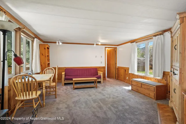 a bedroom with furniture and a large window