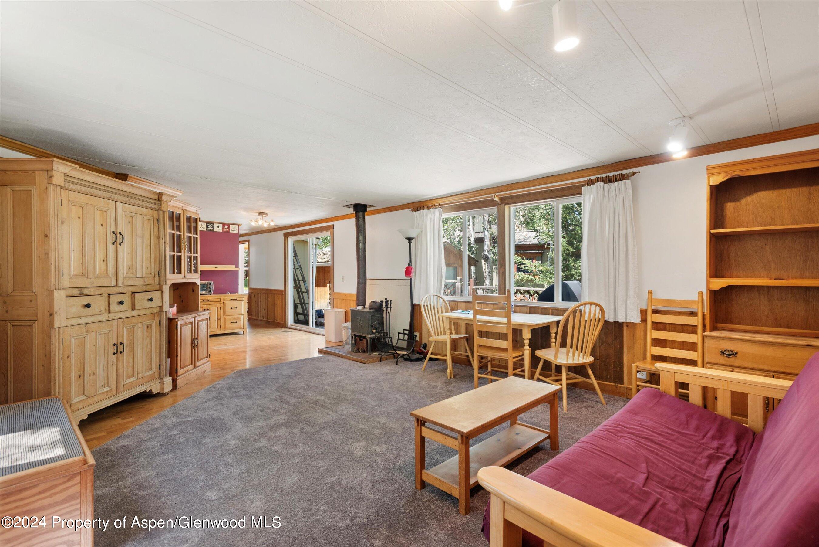 40 Aspen Village Road Aspen, CO 81611 - Photo 4 of 19 a living room with furniture a flat screen tv and large window