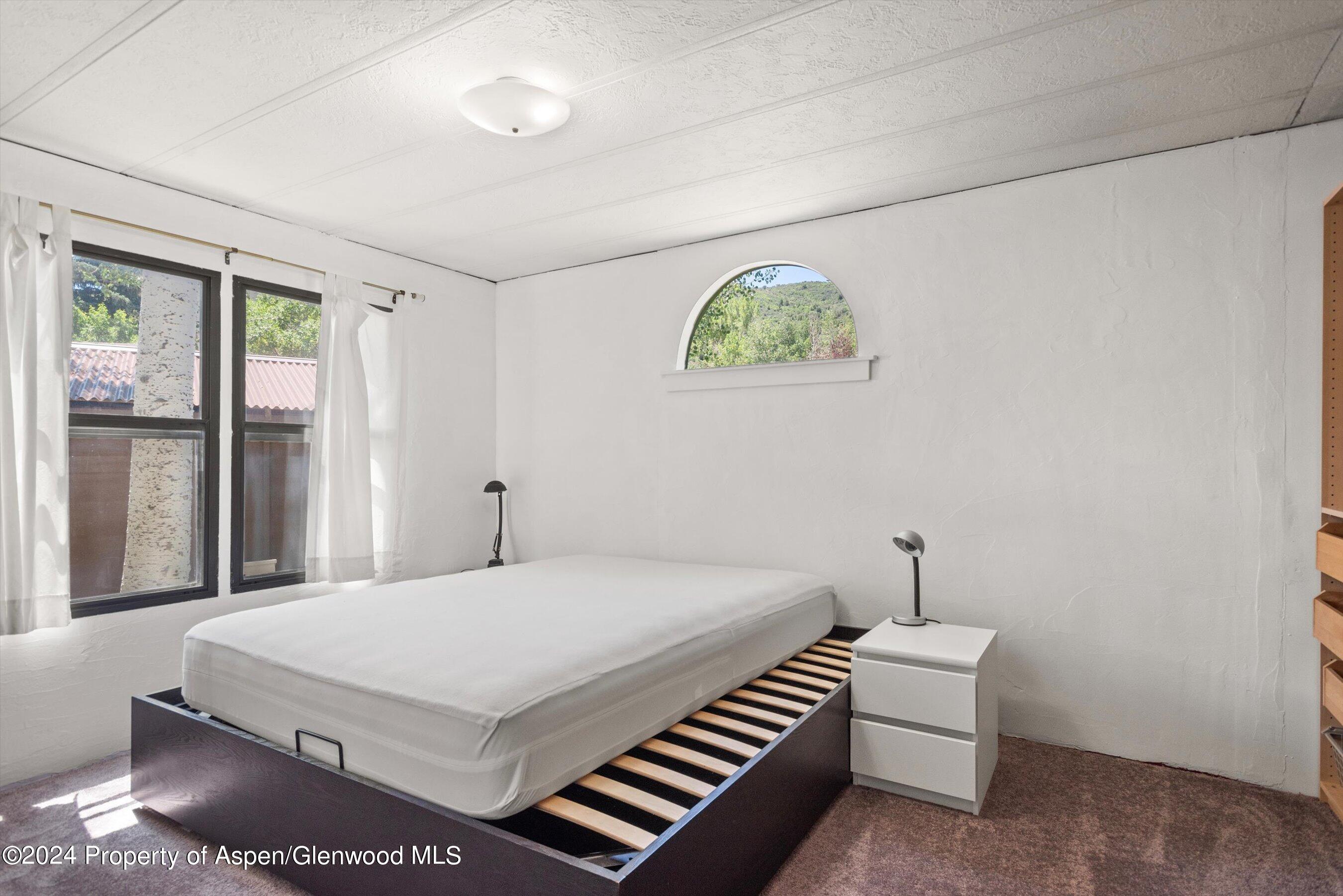 40 Aspen Village Road Aspen, CO 81611 - Photo 5 of 19 a bedroom with a bed and a window