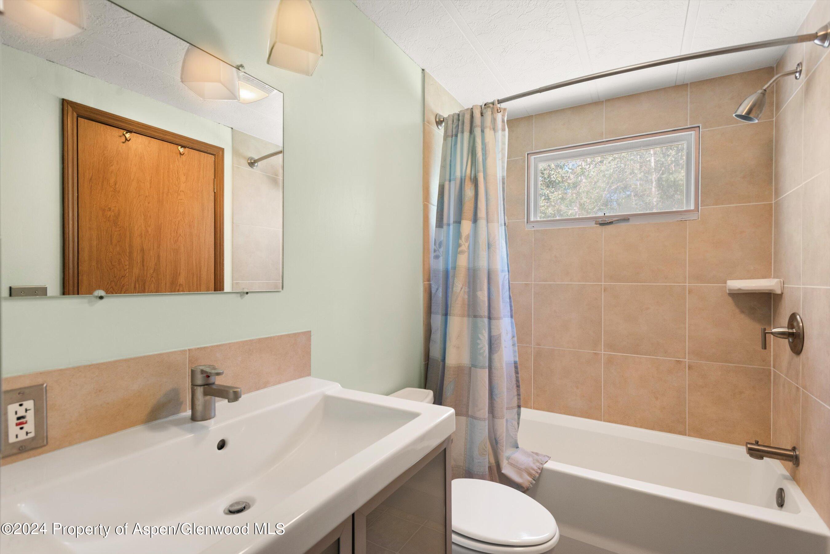 40 Aspen Village Road Aspen, CO 81611 - Photo 10 of 19 a bathroom with a tub sink and a mirror