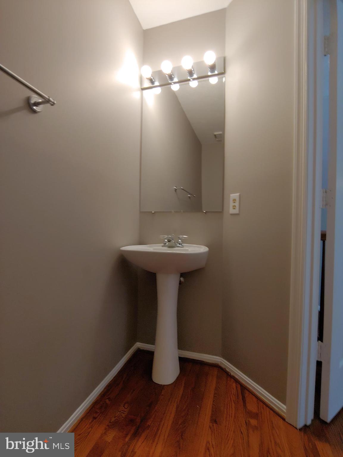 6010 Grenfell Loop Bowie, MD 20720 - Photo 16 of 32 a bathroom with a sink and mirror