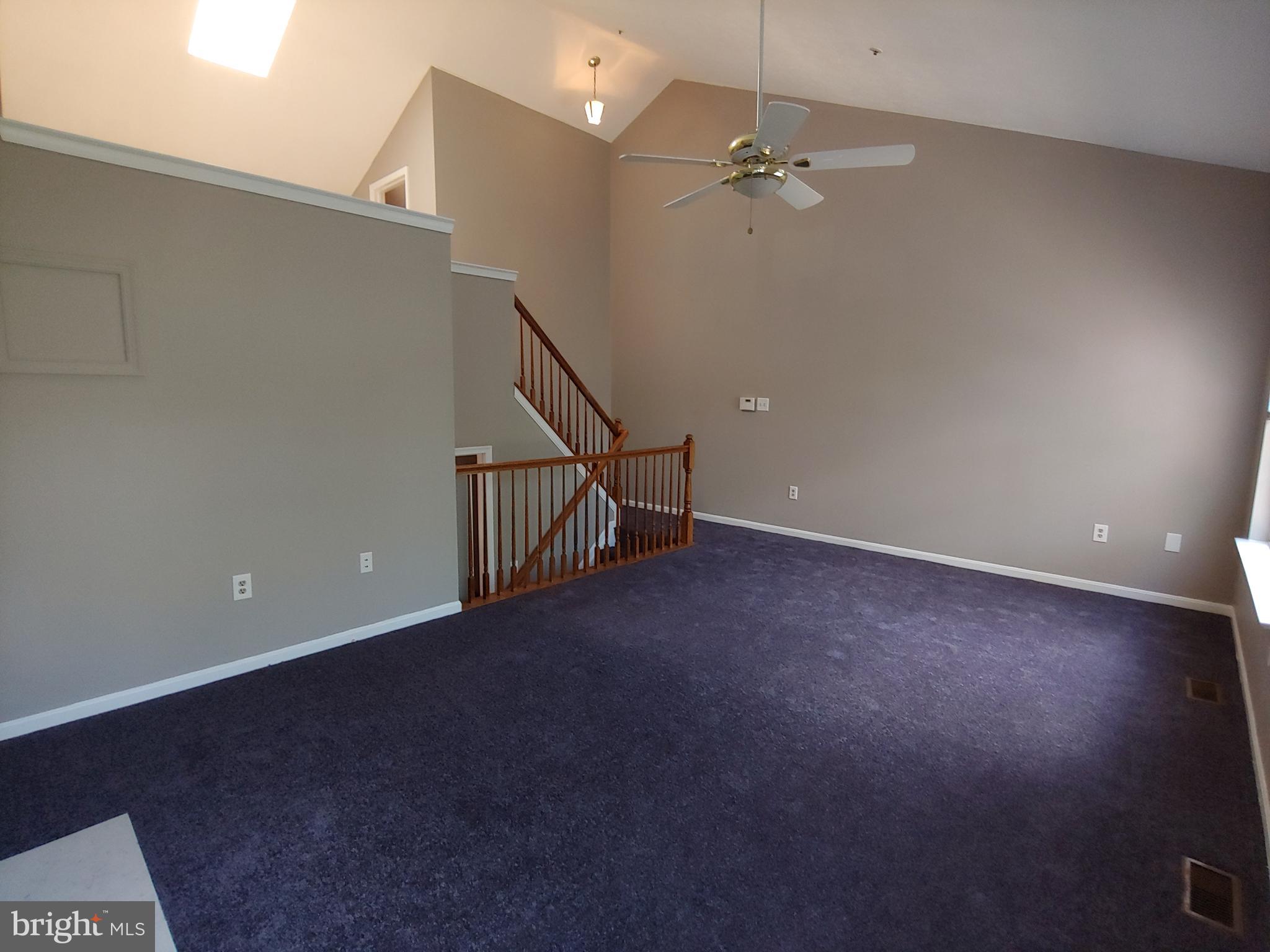 6010 Grenfell Loop Bowie, MD 20720 - Photo 25 of 32 a view of a room with stairs and a chandelier fan
