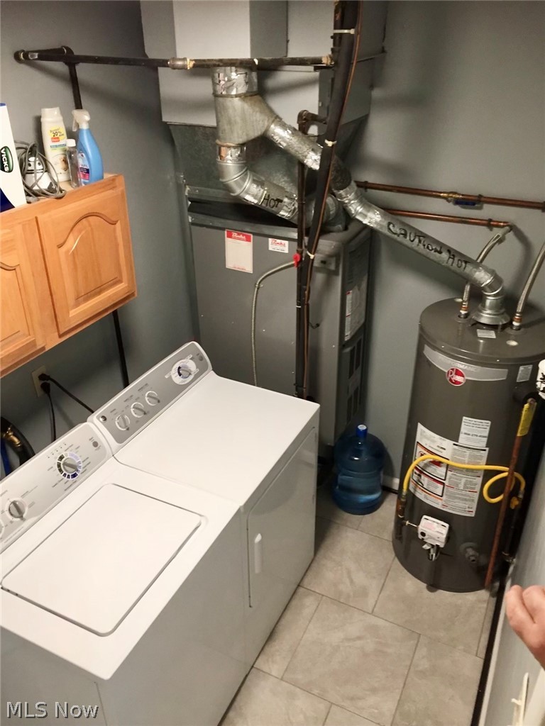 10071 Hazelton Road Streetsboro, OH 44241 - Photo 16 of 16 Washroom with washing machine and dryer, water heater, cabinets, and light tile floors