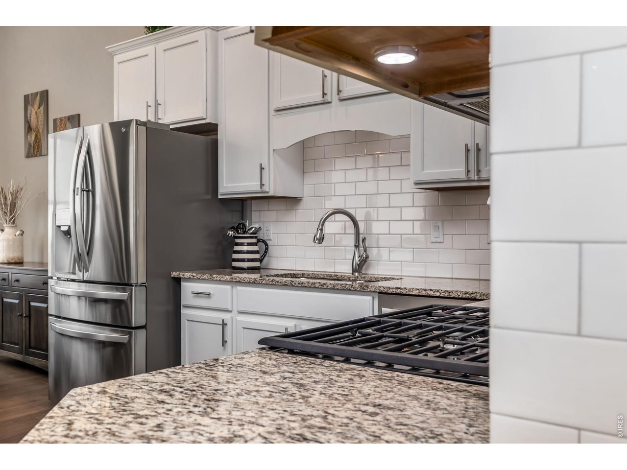 3789 Bridle Ridge Circle Severance, CO 80524 - Photo 19 of 44 a kitchen with stainless steel appliances granite countertop a refrigerator a stove and a sink