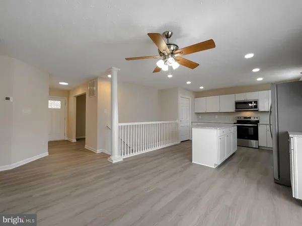 a view of a kitchen with a sink and a refrigerator