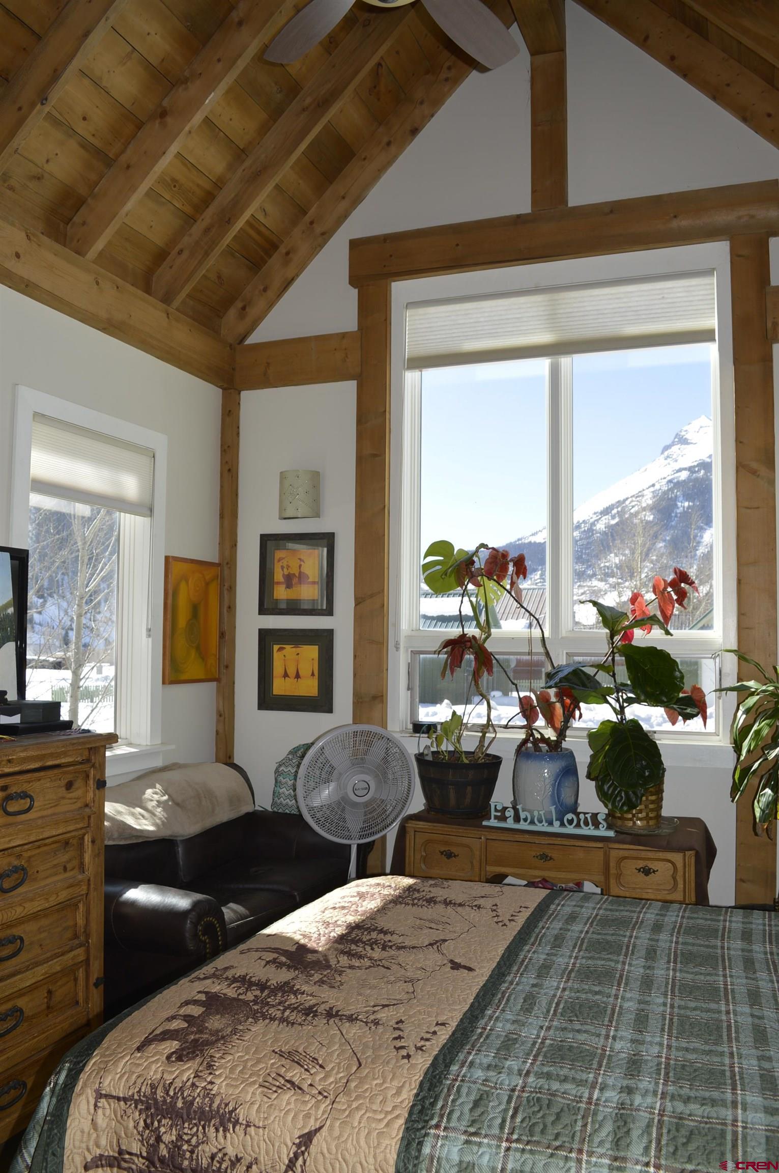 1505 Cement Street Silverton, CO 81433 - Photo 14 of 21 a bedroom with a balcony a bed and a couch