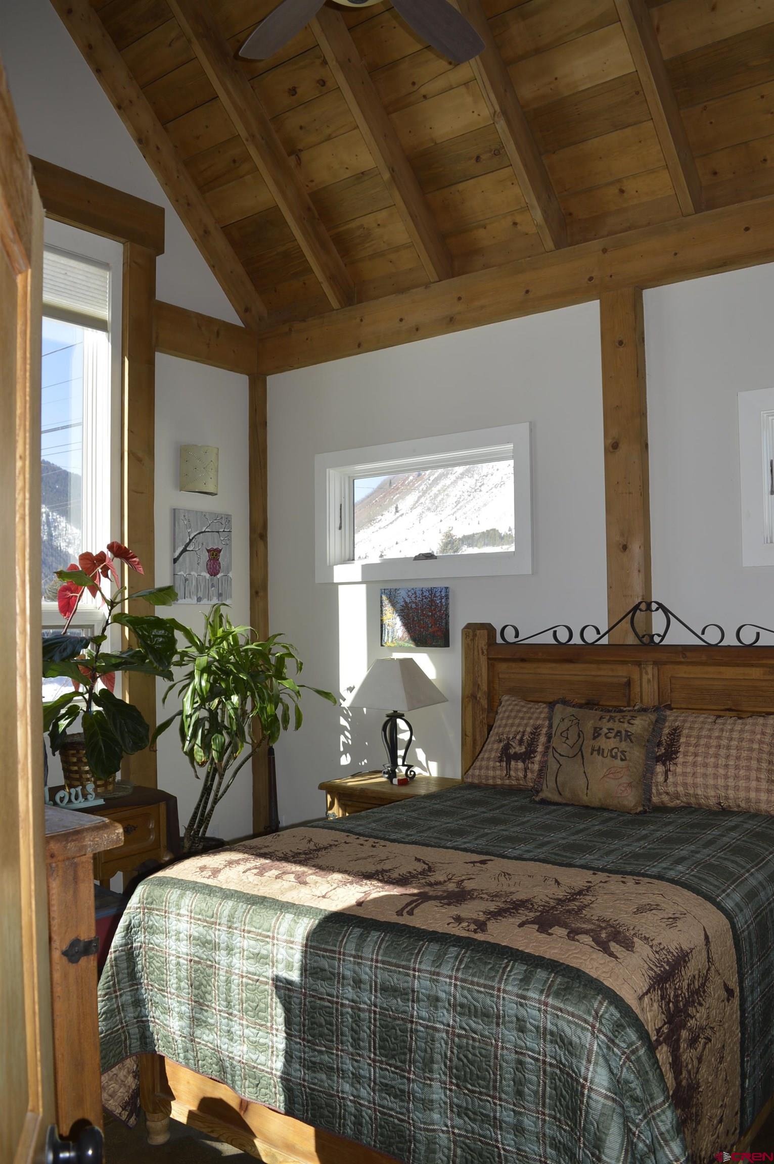 1505 Cement Street Silverton, CO 81433 - Photo 15 of 21 a bedroom with bed and a potted plant