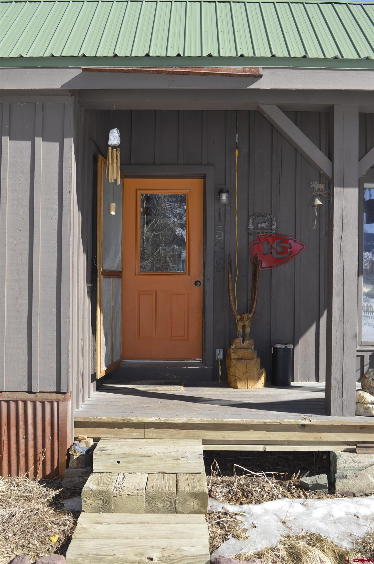 1505 Cement Street Silverton, CO 81433 - Photo 2 of 21 a potted plant sitting in front of a house
