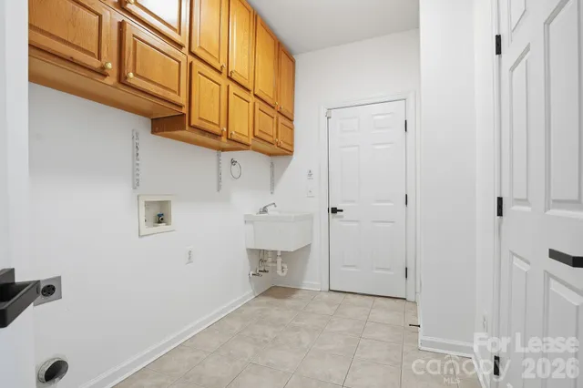 a view of storage and utility room with closet