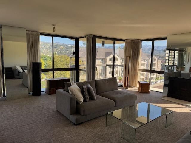 222 Monterey Road, Unit 306 Glendale, CA 91206 - Photo 3 of 32 a living room with furniture and a floor to ceiling window