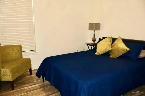 a bedroom with a bed and a couch