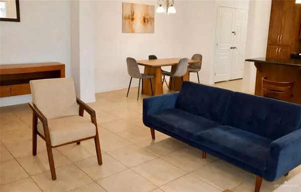 a living room with furniture and a lamp