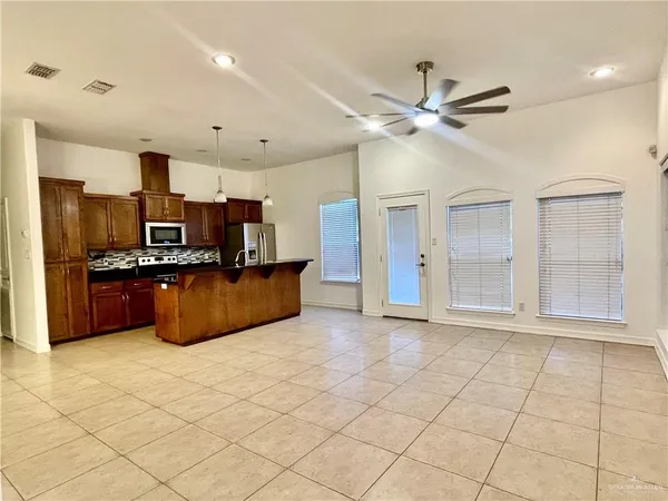 a large kitchen with cabinets and stainless steel appliances