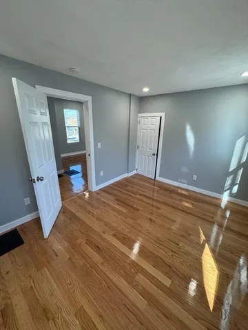 a bedroom with a bed and a mirror