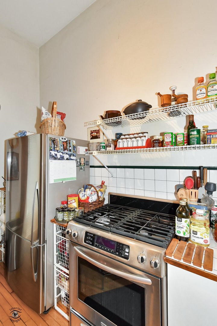1515 West Jackson Boulevard Chicago, IL 60607 - Photo 19 of 21 a kitchen with stainless steel appliances granite countertop a stove and a refrigerator