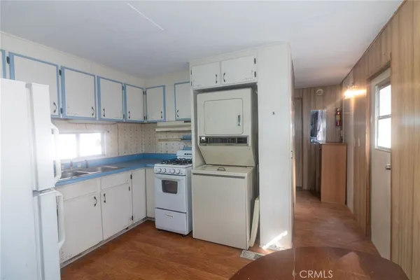 a kitchen with stainless steel appliances granite countertop a refrigerator and a stove