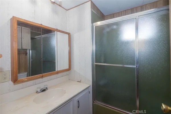a bathroom with a shower and a sink