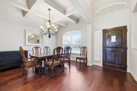 a view of a dining room with furniture wooden floor and chandelier