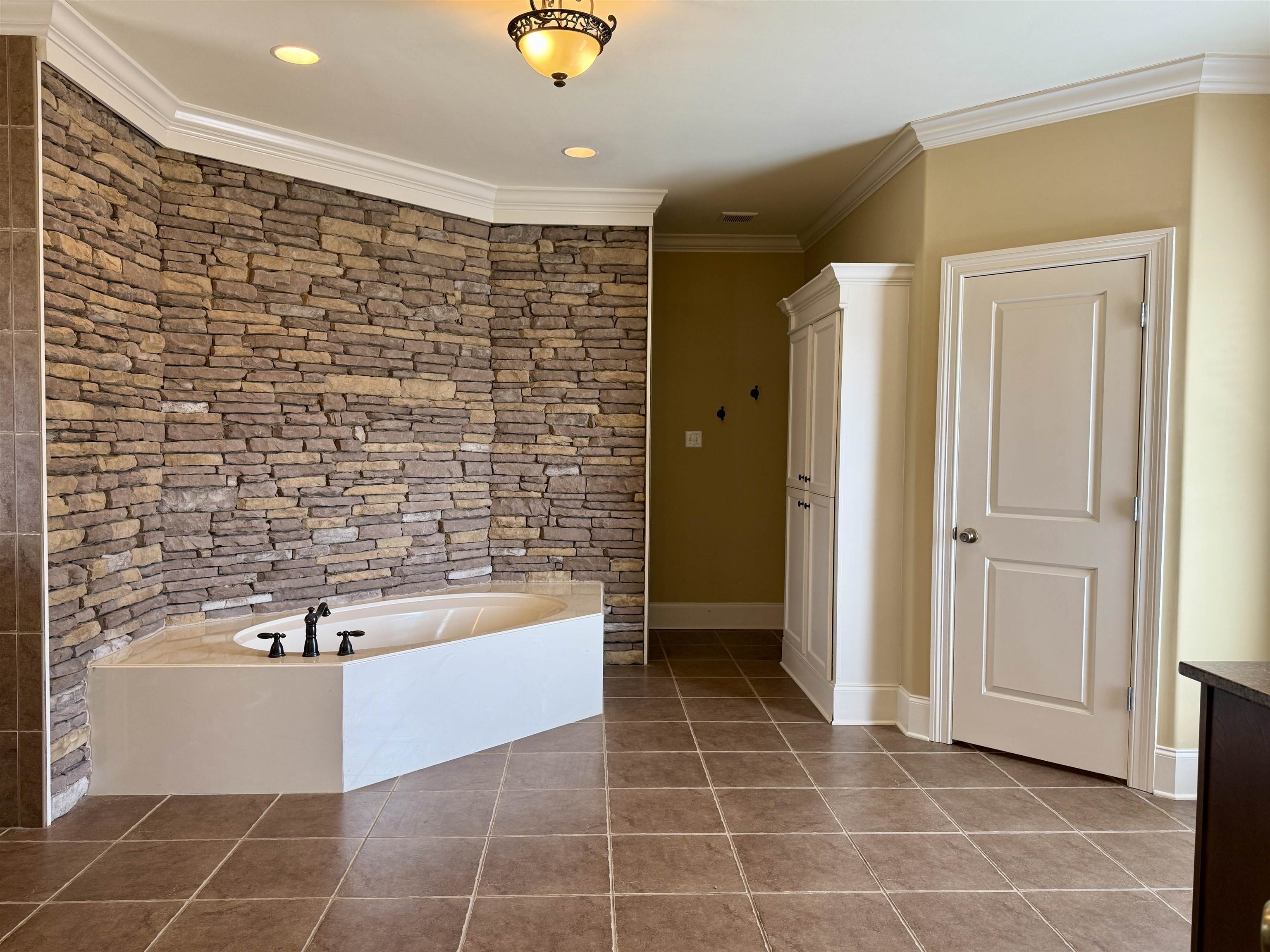 200 Diffee Road Moscow, TN 38057 - Photo 22 of 33 Bathroom with tile patterned flooring, crown molding, and a tub
