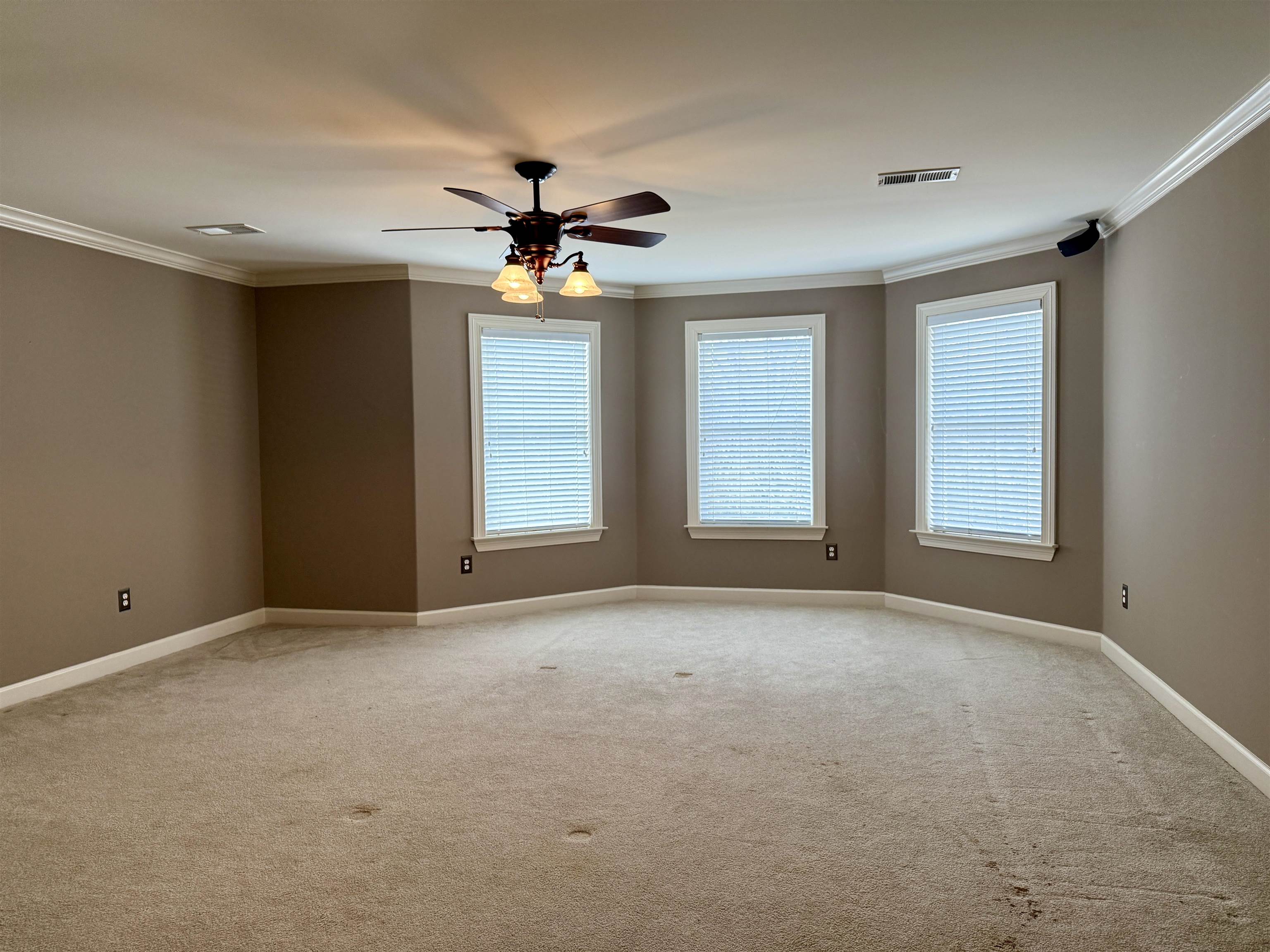200 Diffee Road Moscow, TN 38057 - Photo 25 of 33 Empty room with ornamental molding, light colored carpet, and ceiling fan