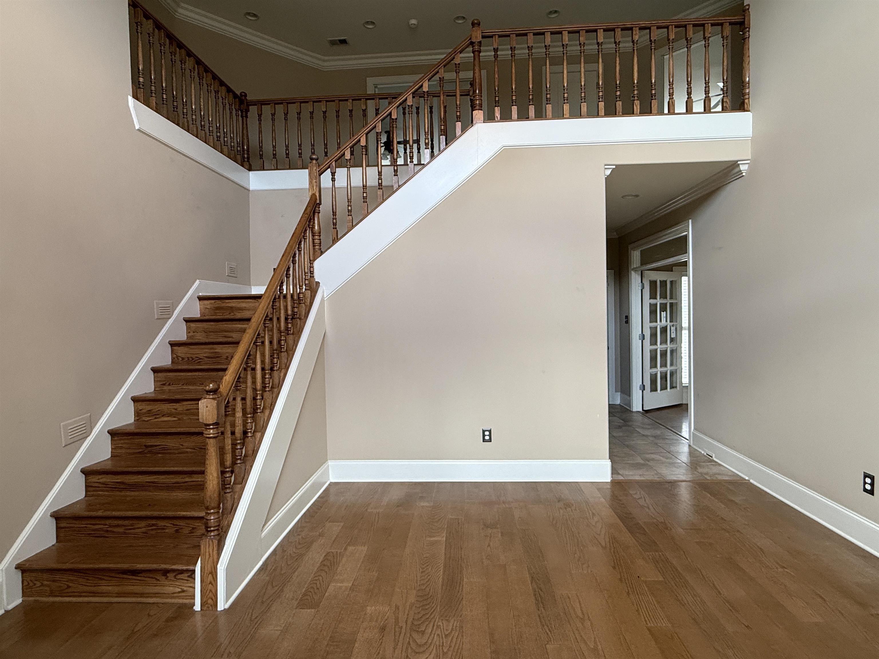 200 Diffee Road Moscow, TN 38057 - Photo 8 of 33 Stairway featuring ornamental molding, hardwood / wood-style floors, and a high ceiling