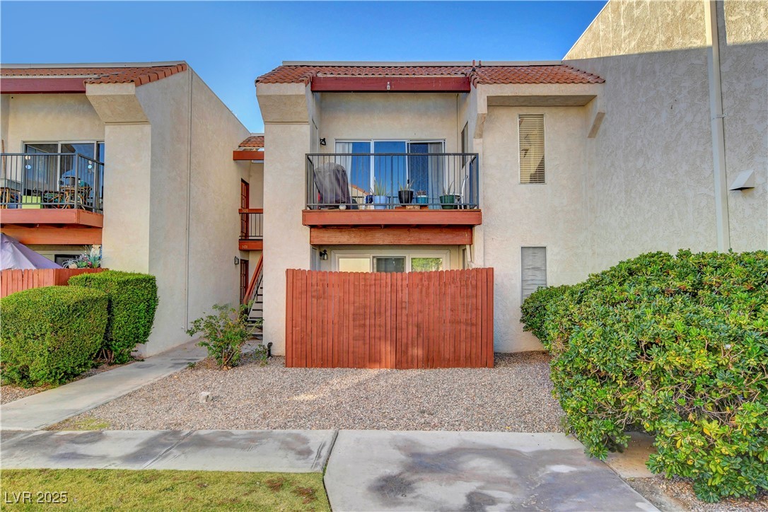 870 B, Unit 506 Boulder City, NV 89005 - Photo 28 of 33 View of front facade featuring stucco siding, a balcony, a tile roof, and stairway