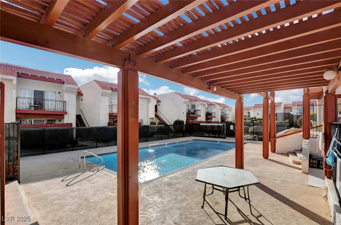 870 B, Unit 506 Boulder City, NV 89005 - Photo 29 of 33 Community pool with a patio area, a pergola, and a residential view