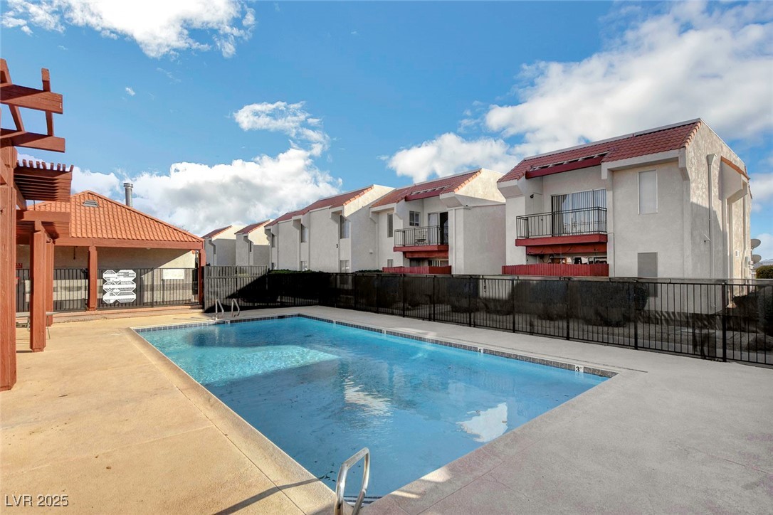 870 B, Unit 506 Boulder City, NV 89005 - Photo 30 of 33 Community pool with a residential view, a patio area, and a pergola