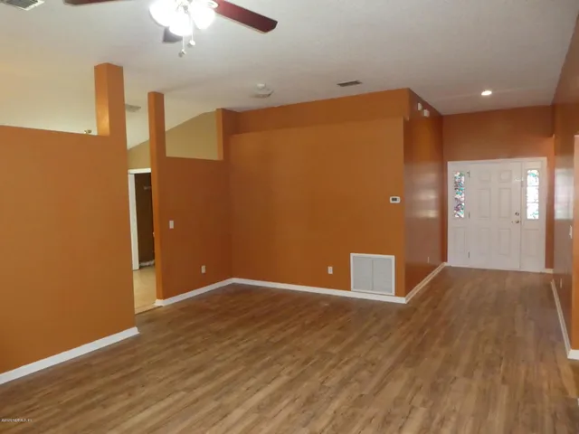 a view of an entryway with wooden floor