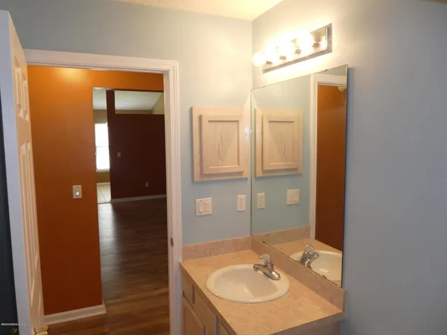 a kitchen with a refrigerator and a sink