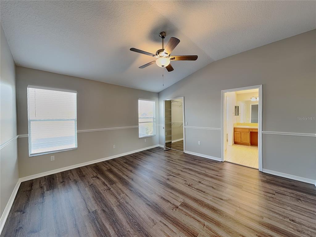 Undisclosed Address Land O' Lakes, FL 34639 - Photo 11 of 25 an empty room with wooden floor and windows