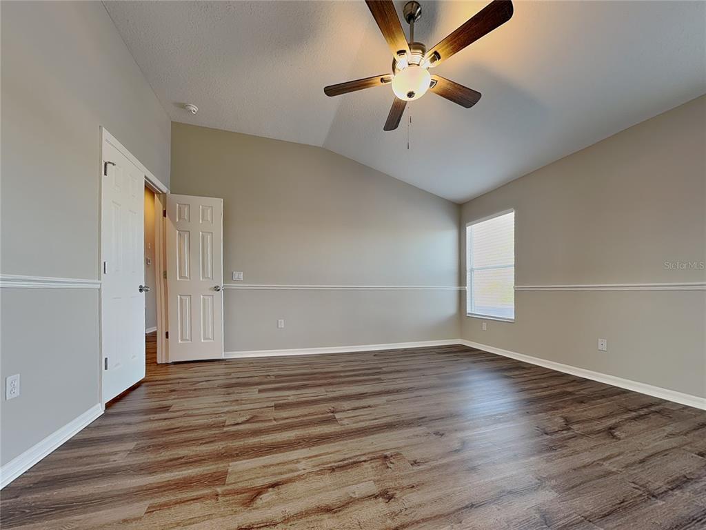 Undisclosed Address Land O' Lakes, FL 34639 - Photo 12 of 25 wooden floor in an empty room with a window