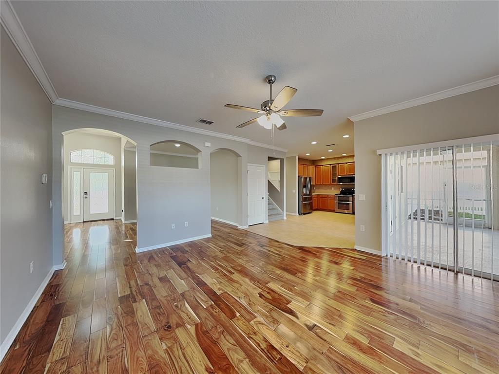 Undisclosed Address Land O' Lakes, FL 34639 - Photo 3 of 25 a view of livingroom with hardwood floor and a ceiling fan